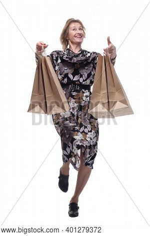 Full length of attractivewoman smiling and carrying shopping bags while dancing