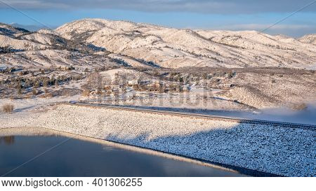 mountain lake and dam at foothills of Rocky Mountains in sunrise light, Horsetooth Reservoir - a popular recreational area in northern Colorado