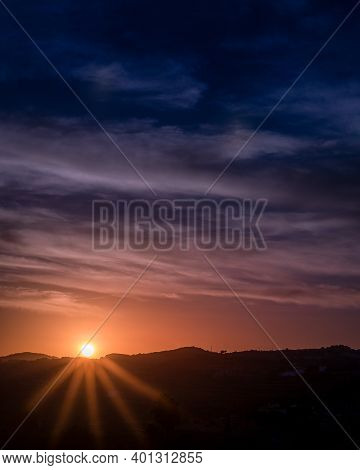 Beautiful Sunset With A Starrry Sun And A Yellow And Blue Sky Full Of Clouds In The Golden Hour