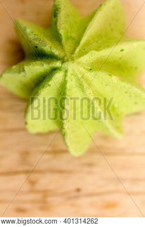 Green, Sweet, Crispy Meringue Close-up On A Wooden Background.