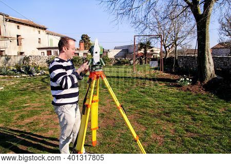 Man Using Of Total Station. Guy Surveyor At Work. Survey Instrument Geodetic Device, Total Station S