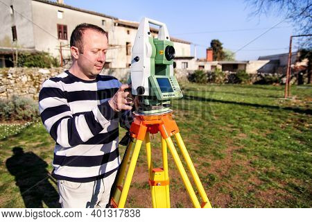 Man Using Of Total Station. Guy Surveyor At Work. Survey Instrument Geodetic Device, Total Station S