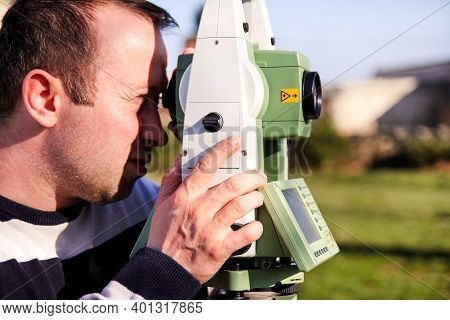 Man Using Of Total Station. Guy Surveyor At Work. Survey Instrument Geodetic Device, Total Station S