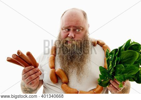An Overweigh Man Choosing What Is Better For Health! Sausages Or Greens