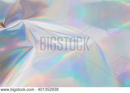 Rainbow Halographic Wrinkled Foil Background. Abstract Pastel Color Background.