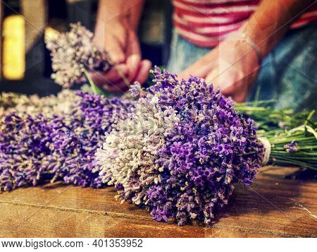 Artist Creating Lavander Bunch. Wooden Table With Lavender. Wood Tabletop With Flowers Abstract Filt