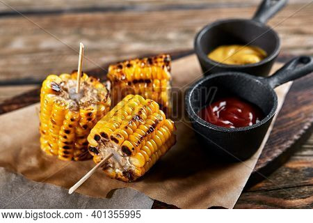 Corn Grilled With Salt And . Dark Background. Fast Food In The Summer.