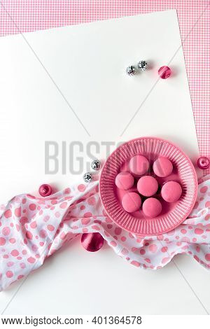 Pink Macaroons On A Plate. Flat Lay With Spotty Towel, Disco Balls And Metallic Balls. Simple Monoch