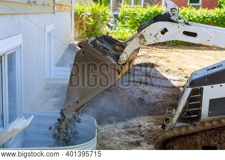 Bucket Standing On Gravel Stones, New House Under Construction Window Well Craft Basement Constructi