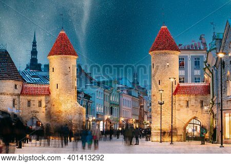 Tallinn, Estonia. Night Starry Sky Above Famous Landmark Viru Gate Gates. Street Lighting In Winter 