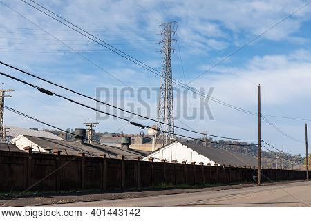 Large Steel Mill Manufacturing Facility Behind A Large Wall, Street View, Horizontal Aspect