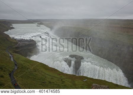 People Visiting And Experiencing The Power Of Popular Tourist Destination - Gullfoss Waterfall On Hv