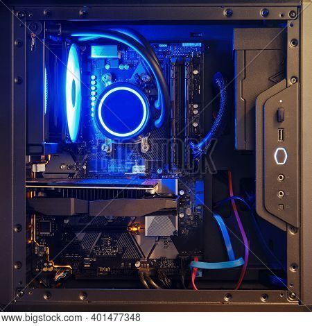 Computer Components Inside The System Unit With Blue Light Liquid Cooling