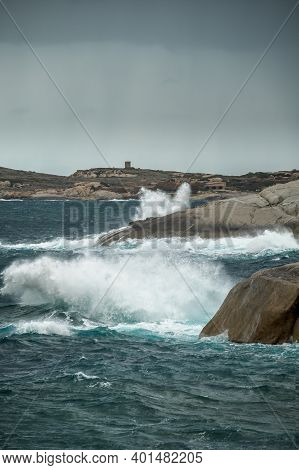 Stormy Mediterranean Sea Crashing Onto The Rocky Coastline At Punta Caldanu In The Balagne Region Of