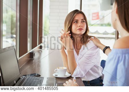 Beauitful Woman Looking Upset, Talking To Her Friend At The Coffee Shop. Depressed Young Woman Chatt