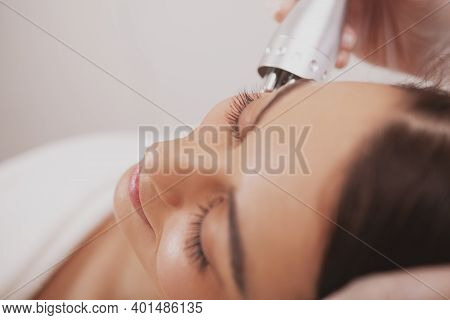 Top View Cropped Close Up Of A Beautiful Woman Smiling, Getting Facial Hardware Treatment At Beauty 