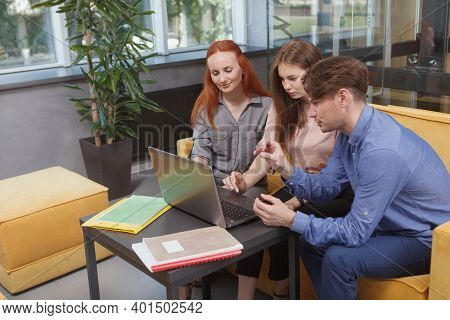 Business Team Using Laptop During Their Meeting At Modern Workspace, Copy Space