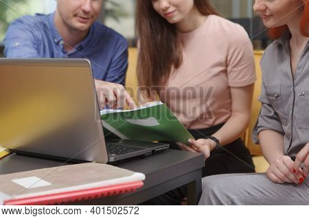 Cropped Shot Of Business People Working Together, Using Laptop