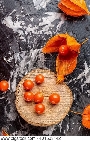 Physalis On Wooden Stump. Ripe Berries Of Autumn Red Physalis Fruit. Berries Fruit. Physalis Or Chin