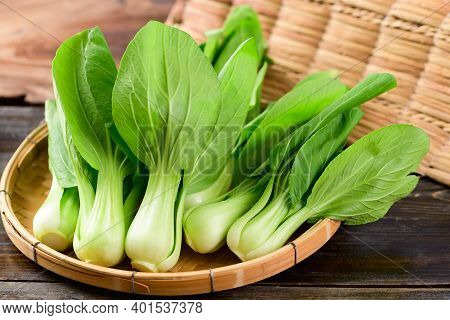 Fresh Bok Choy Or Pak Choi (chinese Cabbage) In Bamboo Basket On Wooden Background, Organic Vegetabl