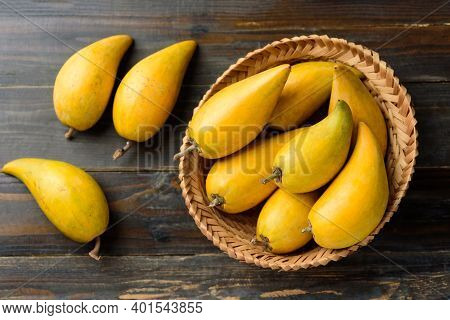Eggfruit Or Canistel In A Basket On Wooden Table, Thai Fruit, In Thai Names Such As Xiantao, Lamut K