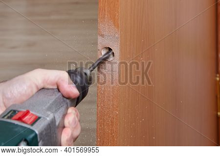 The Carpenter Uses A Flat Bit Shank Drill For Wood To Drilling A Handle Hole With A Lock For An Inte