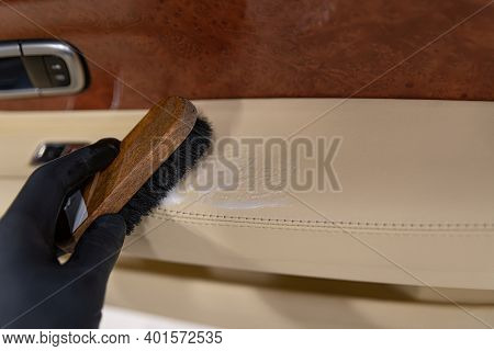 Car Detailing Studio Worker Cleaning Leather Car Interio