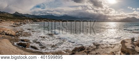 Panoramic View Of Waves Washing Onto The Rocky Coastline Of Calvi Bay In The Balagne Region Of Corsi