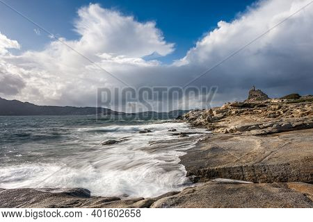 Waves Washing Onto The Rocky Coastline At Punta Caldanu Near Lumio In The Balagne Region Of Corsica 