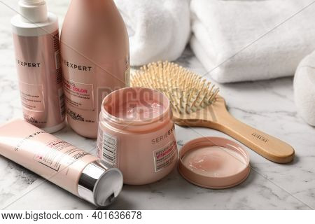 Mykolaiv, Ukraine - August 08, 2020: L'oreal Hair Care Cosmetic Products And Brush On White Marble T