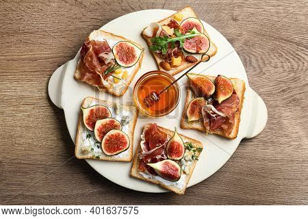 Sandwiches With Figs, Proscuitto And Cheese On Wooden Table, Top View