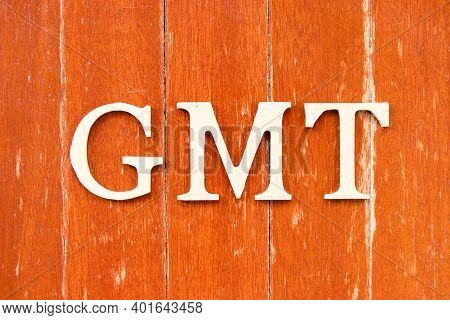 Alphabet Letter In Word Gmt (abbreviation Of Greenwich Mean Time) On Old Red Color Wood Plate Backgr