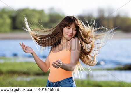Happy Young Woman Dancing In Headphones On The Shore Of The Bay Sun Sunny Spring Day