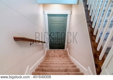 Interior U Shaped Staircase With Wall Mounted Handrail And Leads To The Basement