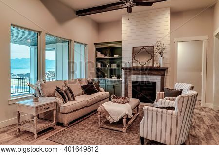 Living Area Of Home With Upholstered Funiture Modern Fireplace And Ceiling Fan
