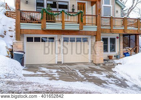 Home In Snowy Utah Neighborhood With Two Car Garage And Balcony At The Facade