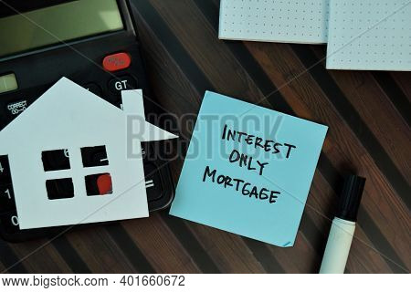 Interest Only Mortgage Write On Sticky Notes Isolated On Wooden Table. Business Or Finance Concept