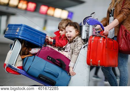 Two Little Kids, Boy And Girl, Siblings And Mother At The Airport. Children, Family Traveling, Going