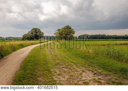 Meandering Path In A Peat Meadow Area In A Polder In The Dutch Province Of Noord-brabant. It Is A Cl