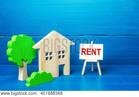 Residential Building Figurine And Easel Rent Sign. Search For Rental Housing. Real Estate Realtor Se