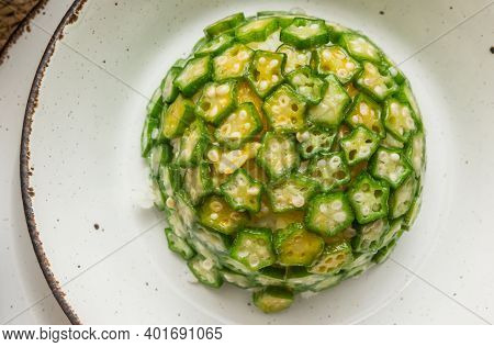 Timbale Of White Rice And Typical Chinese Okra Vegetable