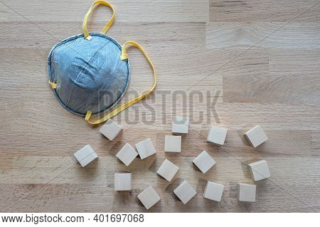 N95 Mask On The Wooden Table With Group Of Wooden Cube For Input Wording,helps Prevent Corona Virus 