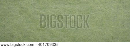background and texture of a green paper made in Bhutan by tsharsho papermaking methods, panoramic banner