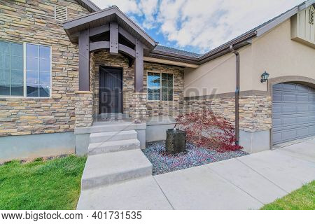 Single Storey House With Stone Brick Wall And Portico And Porch At The Facade