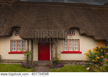 Adare, Ireland. Thatched Cottage In The Picturesque Village Of Adare, Co. Limerick Full Of Flowers I