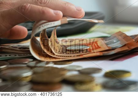 Man Holding A Stack Of American Dollar Bills. Detail Of A Macro Shot. Money Market, Finance, Currenc