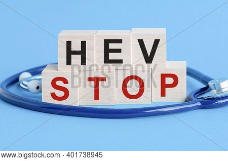 Wooden Block With Words Hev Stop - With Stethoscope On The Table, Insurance And Medical Concept, Blu