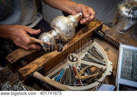 Unrecognized Professional Jewellery Maker Working In Workshop Crafting Silver Vase. Creative People 