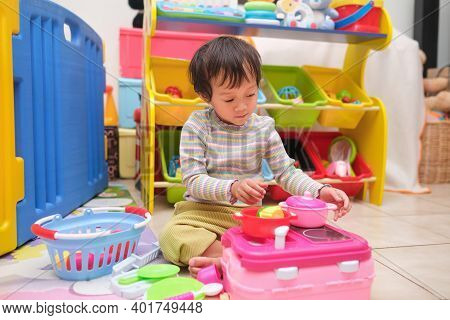 Cute Little Asian 2 - 3 Years Old Toddler Girl Child Having Fun Playing Alone With Cooking Toys, Kit