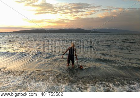 Banyuwangi, Indonesia - May 14, 2020 : A Woman Playing With The Dogs At Watudodol Beach Banyuwangi I